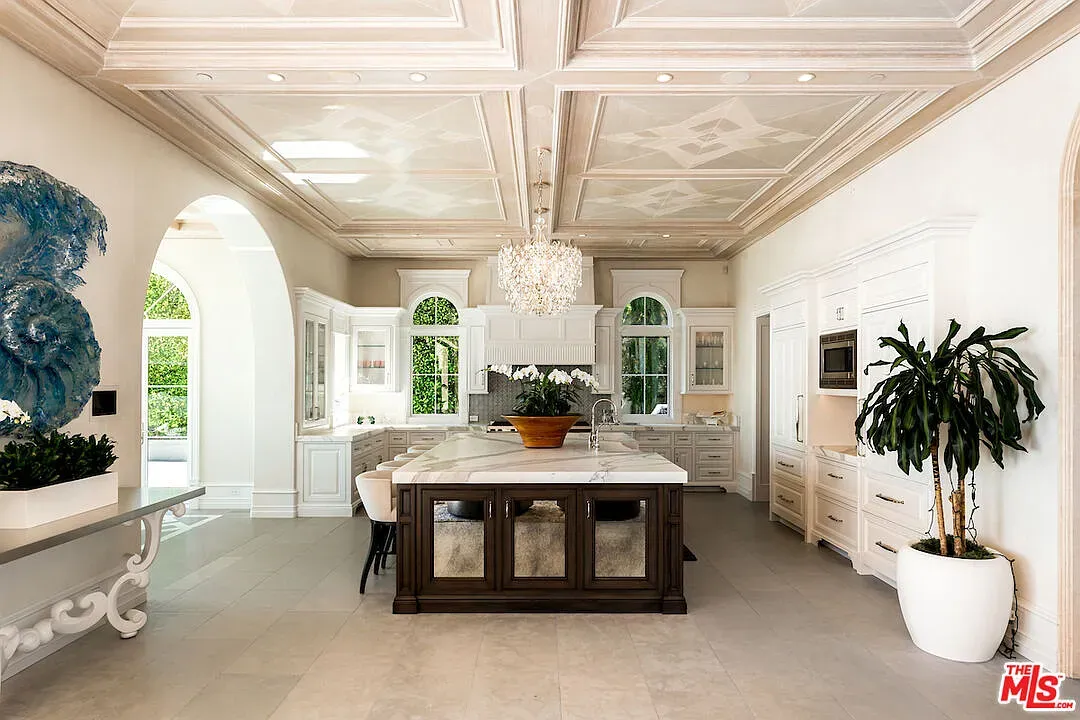 Here's the kitchen—coffered ceiling, warm woods, creamy cabinets. Anyone know that countertop stone?