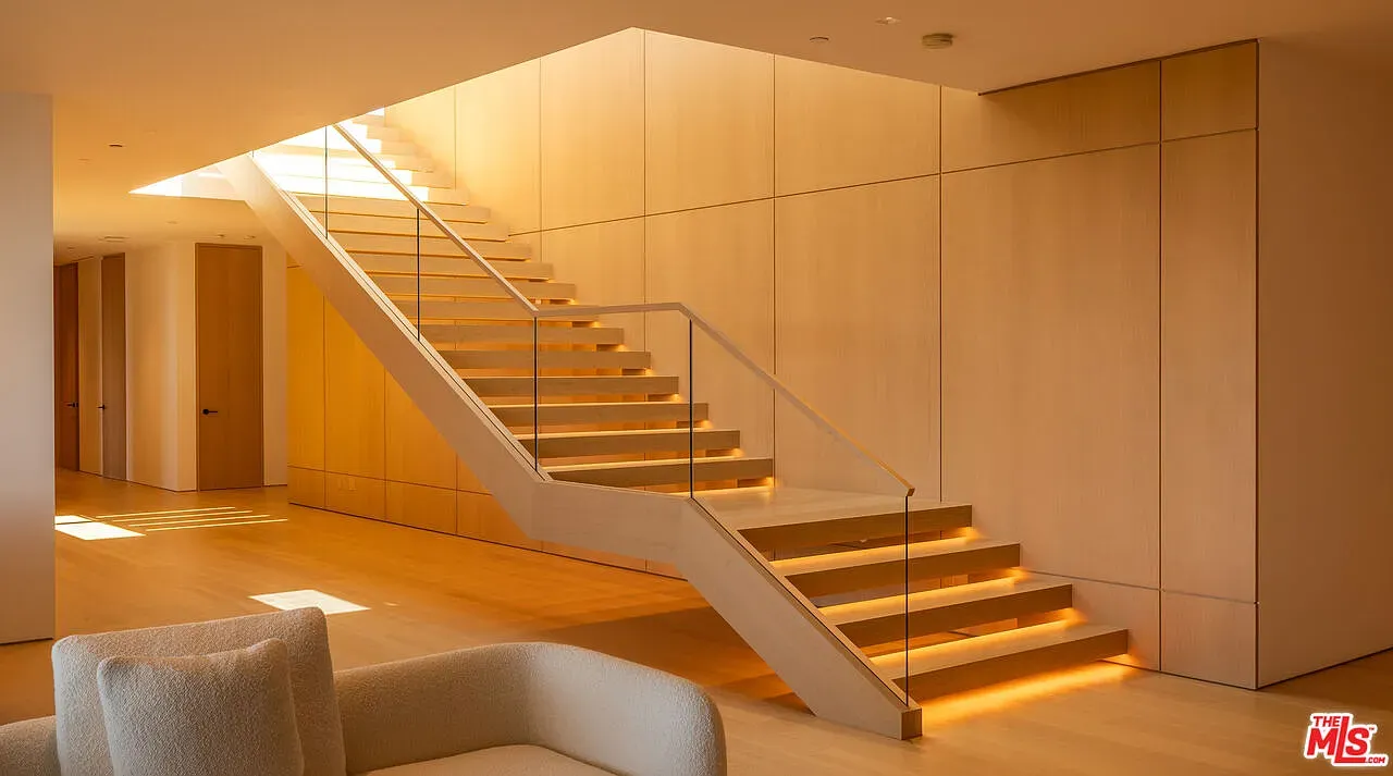 Okay, this stair — pale wood, glass rails. Anyone know why open risers?