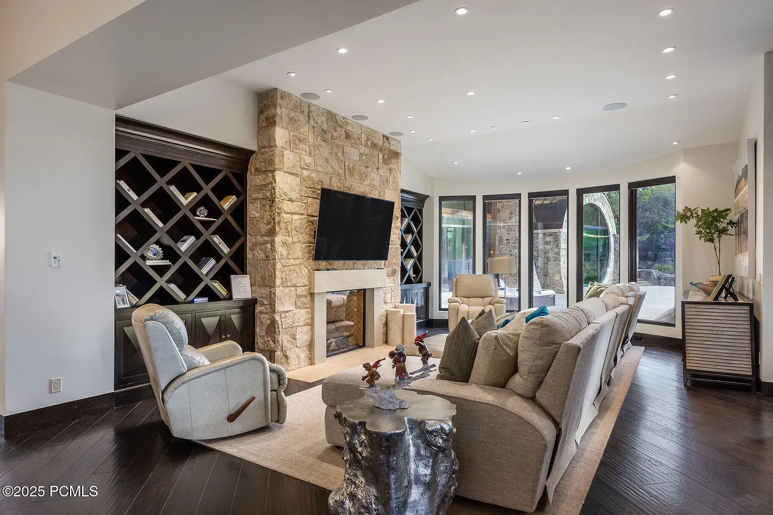 Big stone fireplace against calm walls. Cozy meets sleek, not overdone.