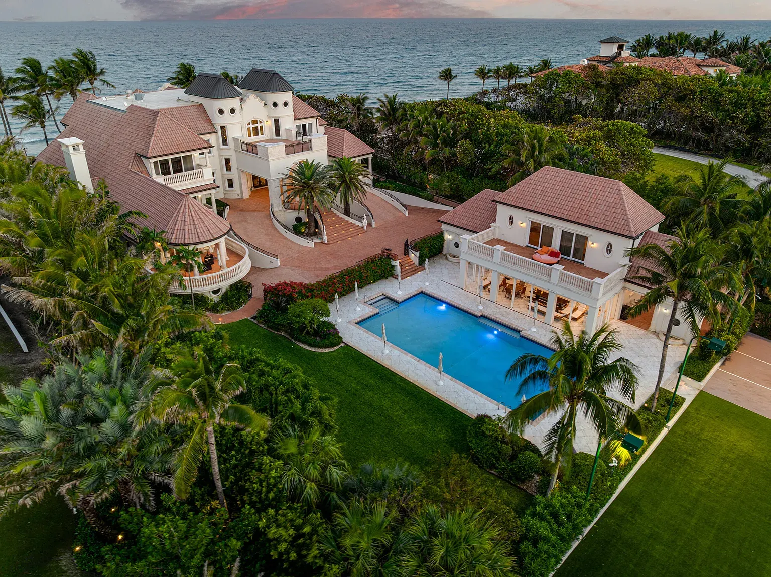 Back outside—pastel stucco, terracotta roof, palms doing the movie entrance.
