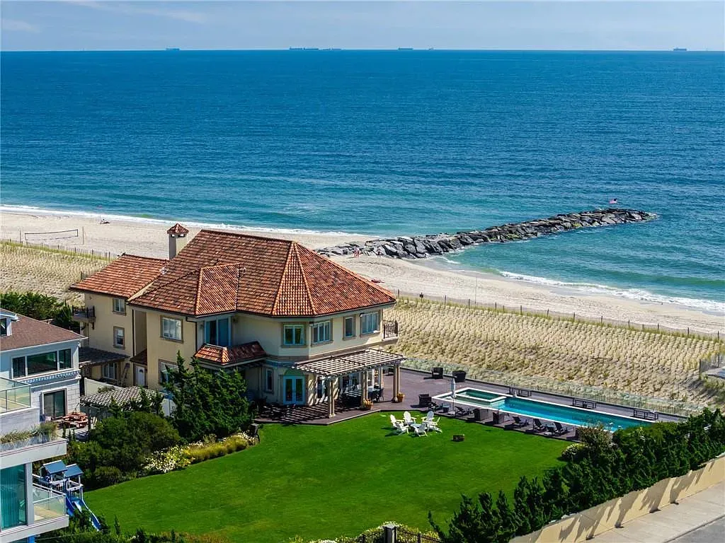Back outside, same sandy stucco and terracotta, bigger glass. Looks expensive.
