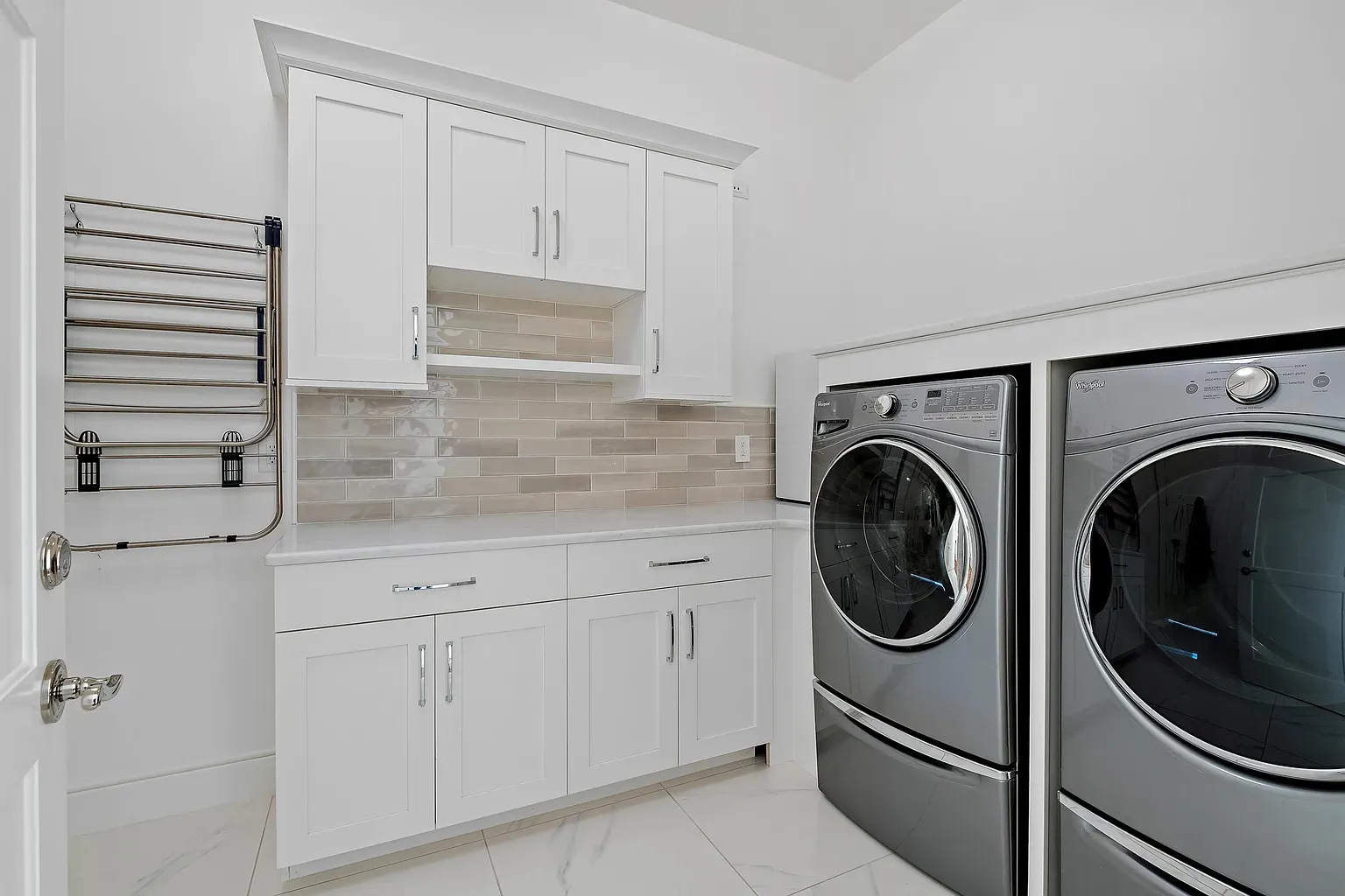 Even the laundry room is spotless and shiny. Folding might be fun here.