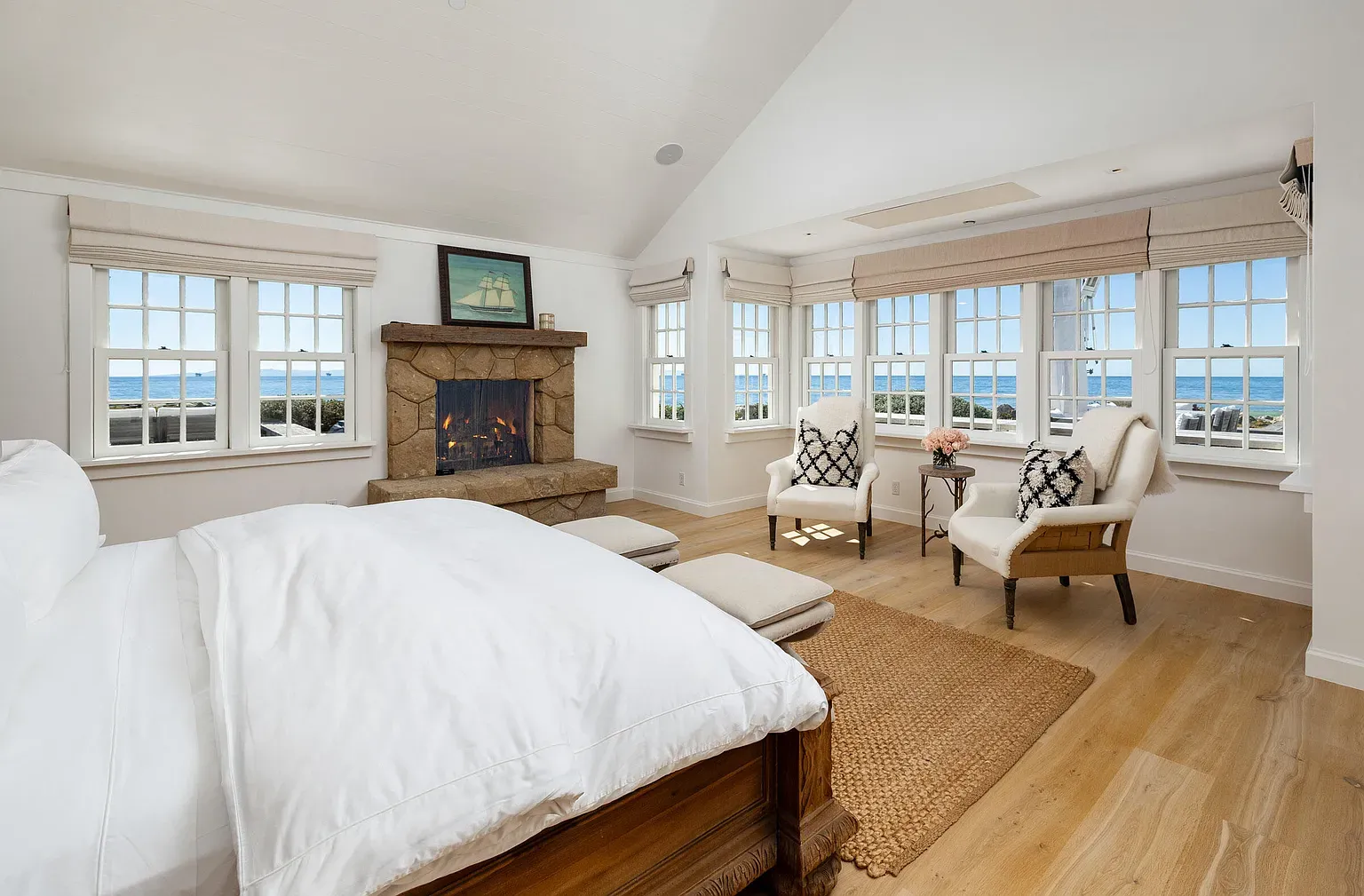 Bedroom stays light and breezy. Vaulted ceiling, white bedding, easy morning vibes.