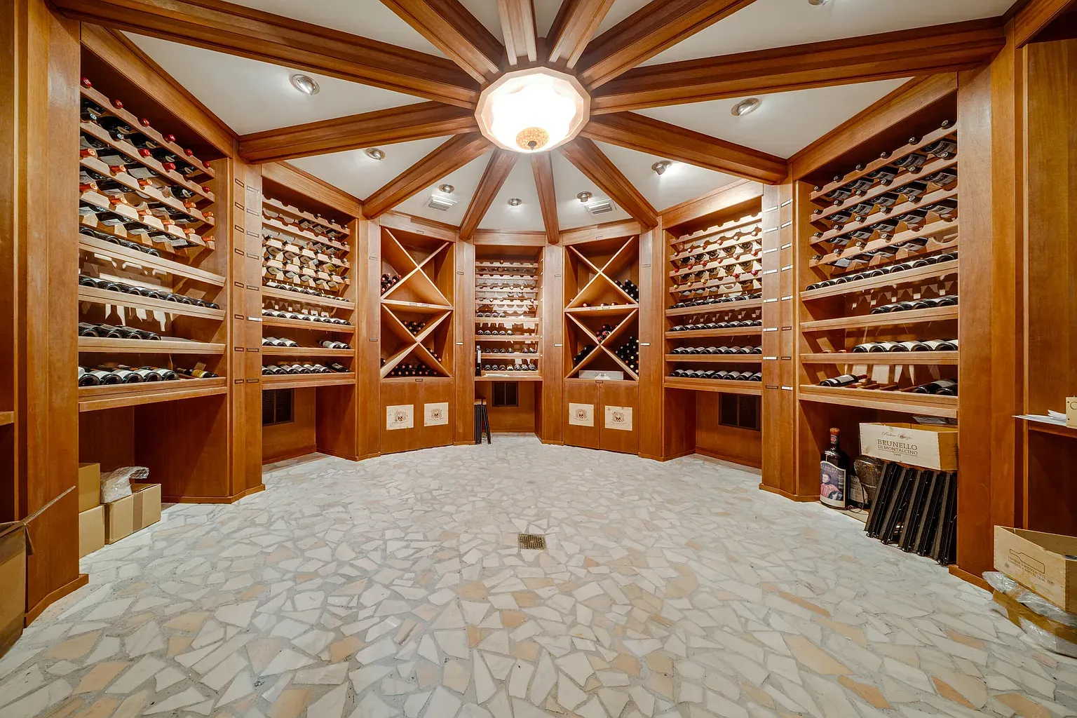 Wine cave energy—dark wood, endless racks, dramatic coffered ceiling flex.