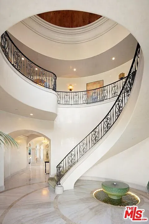 Here’s the entry—marble mirror floor, spiral ironwork. Dramatic first impression.