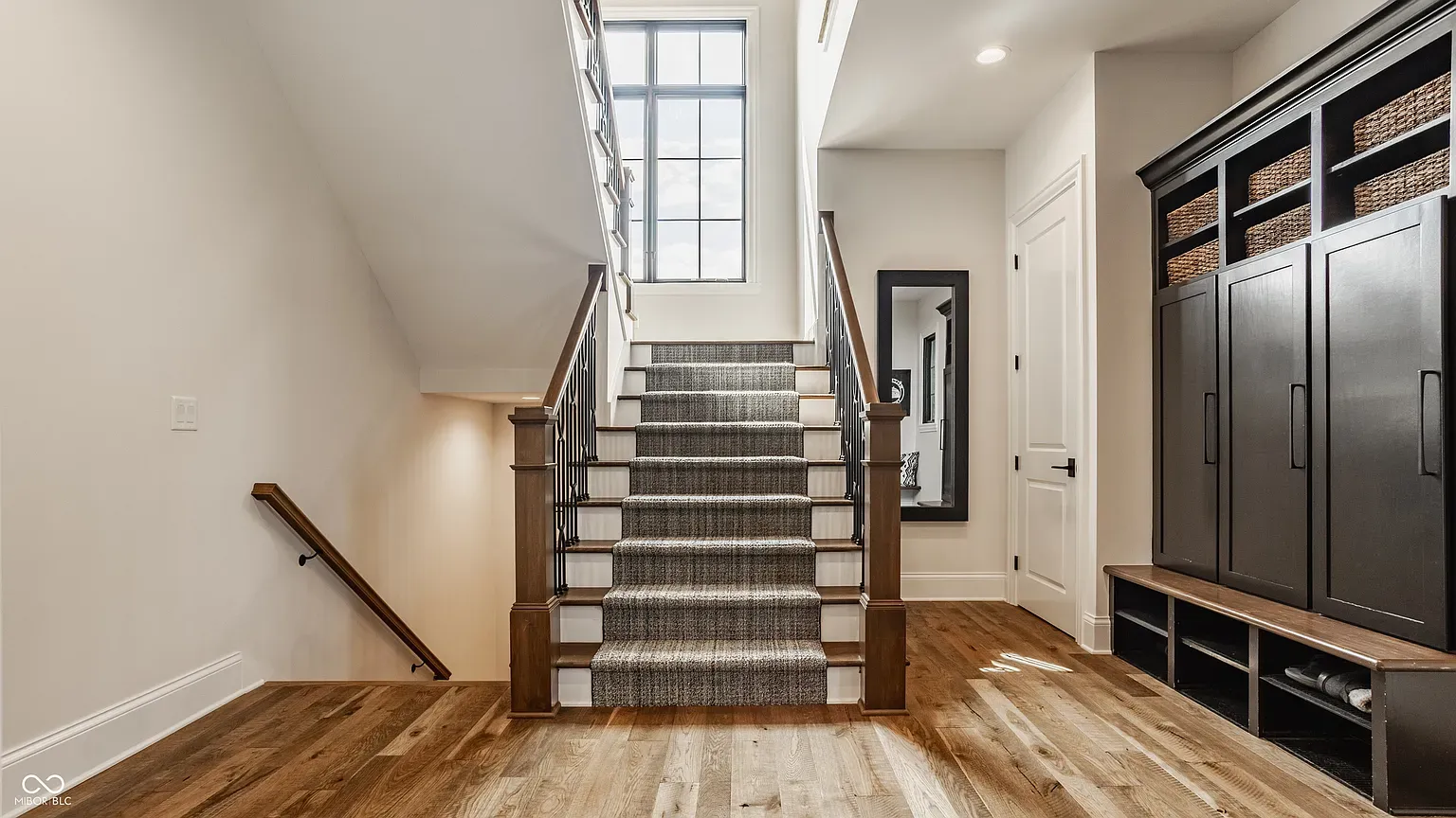 Entry stairs with a runner that actually looks cozy, not hotel.