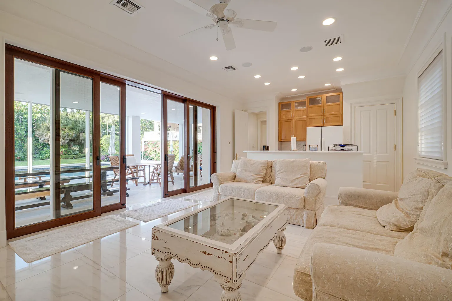 From this corner, huge sliders, white walls—indoor-outdoor actually works.