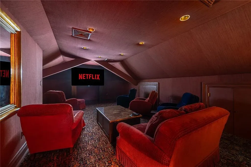 Attic theater with burgundy slopes. Retro cozy, popcorn mandatory.
