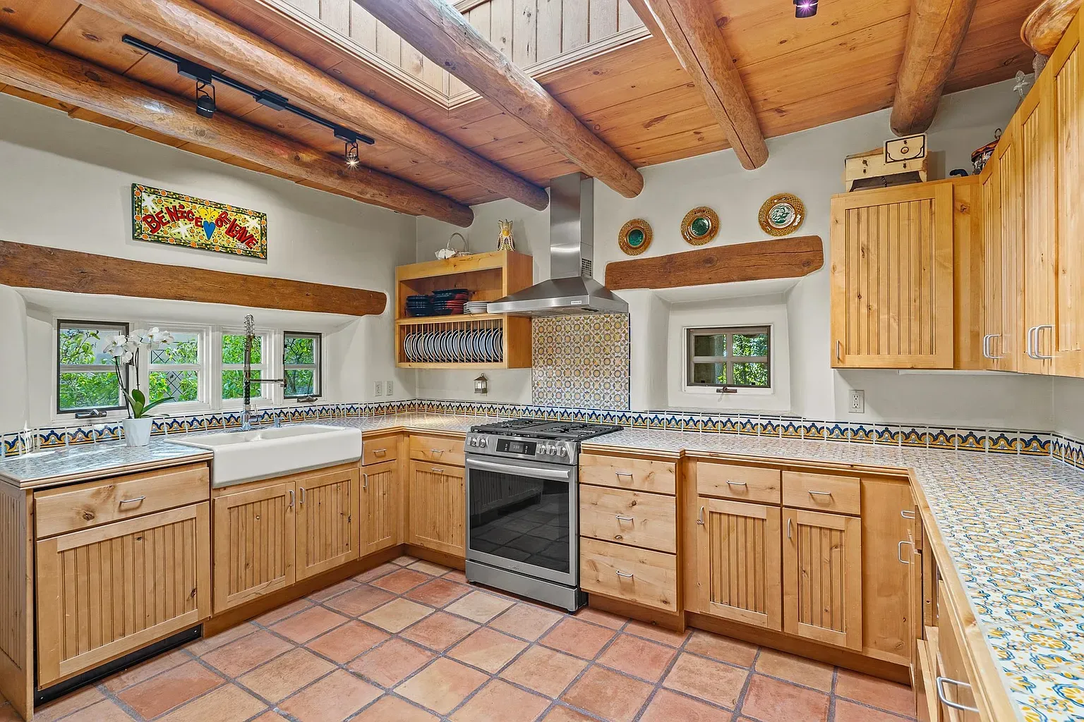 Creamy walls, honey wood cabinets, and beams. Actual cooking might happen here.