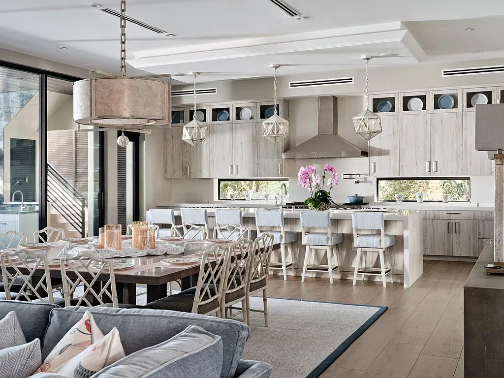 Soft gray and beige kitchen-dining. Minimal, warm lighting, everything quietly expensive.