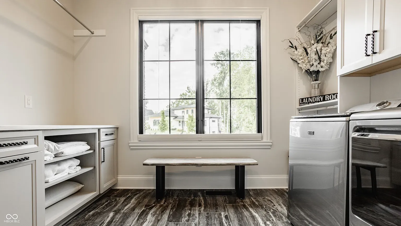 Laundry room glow-up. Big counter and light for folding without hating life.