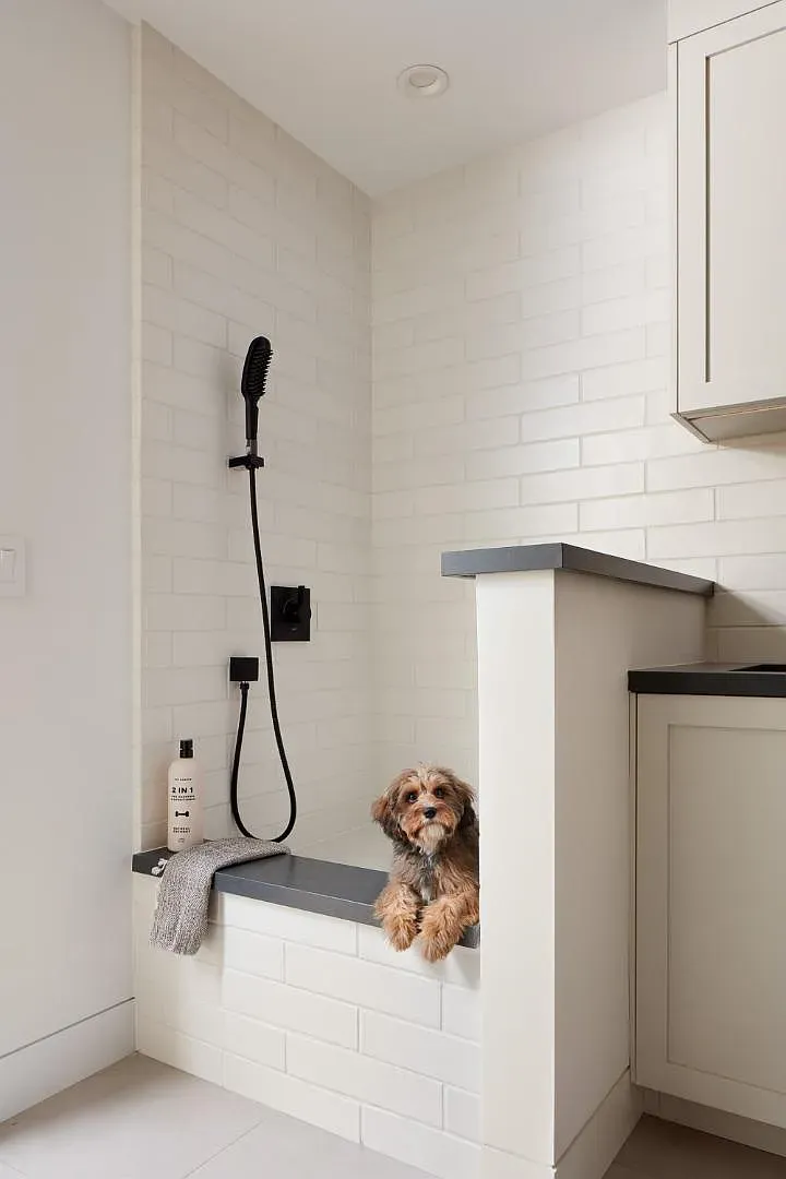 Built-in dog wash with white subway tile. Very practical, very cute.