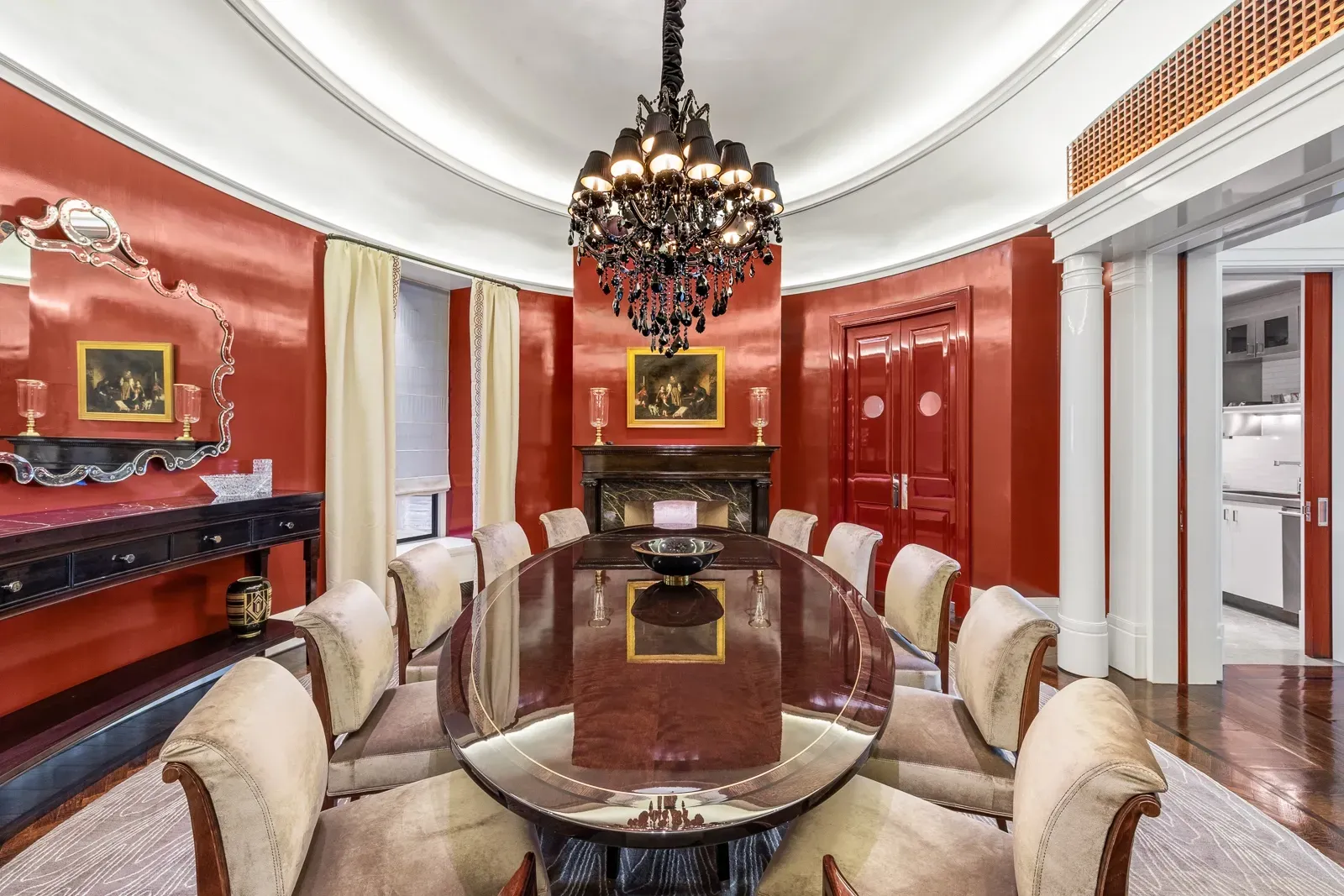 Deep red dining room, dramatic vibe. Fancy chandelier, feels date night.