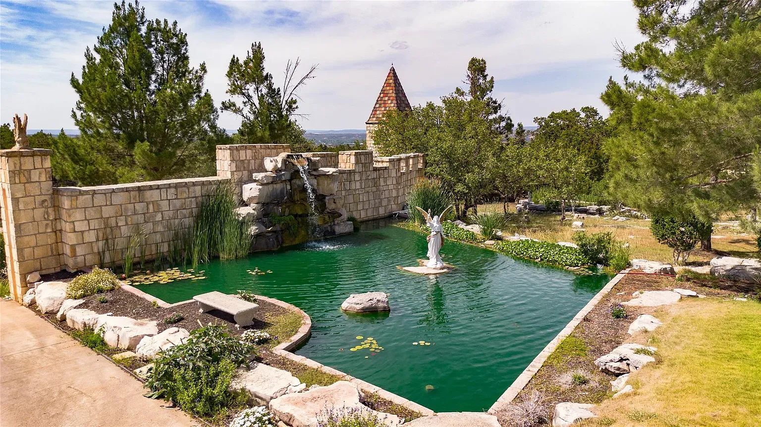 Backyard pond with a statue. Green water mirror moment, super calm.