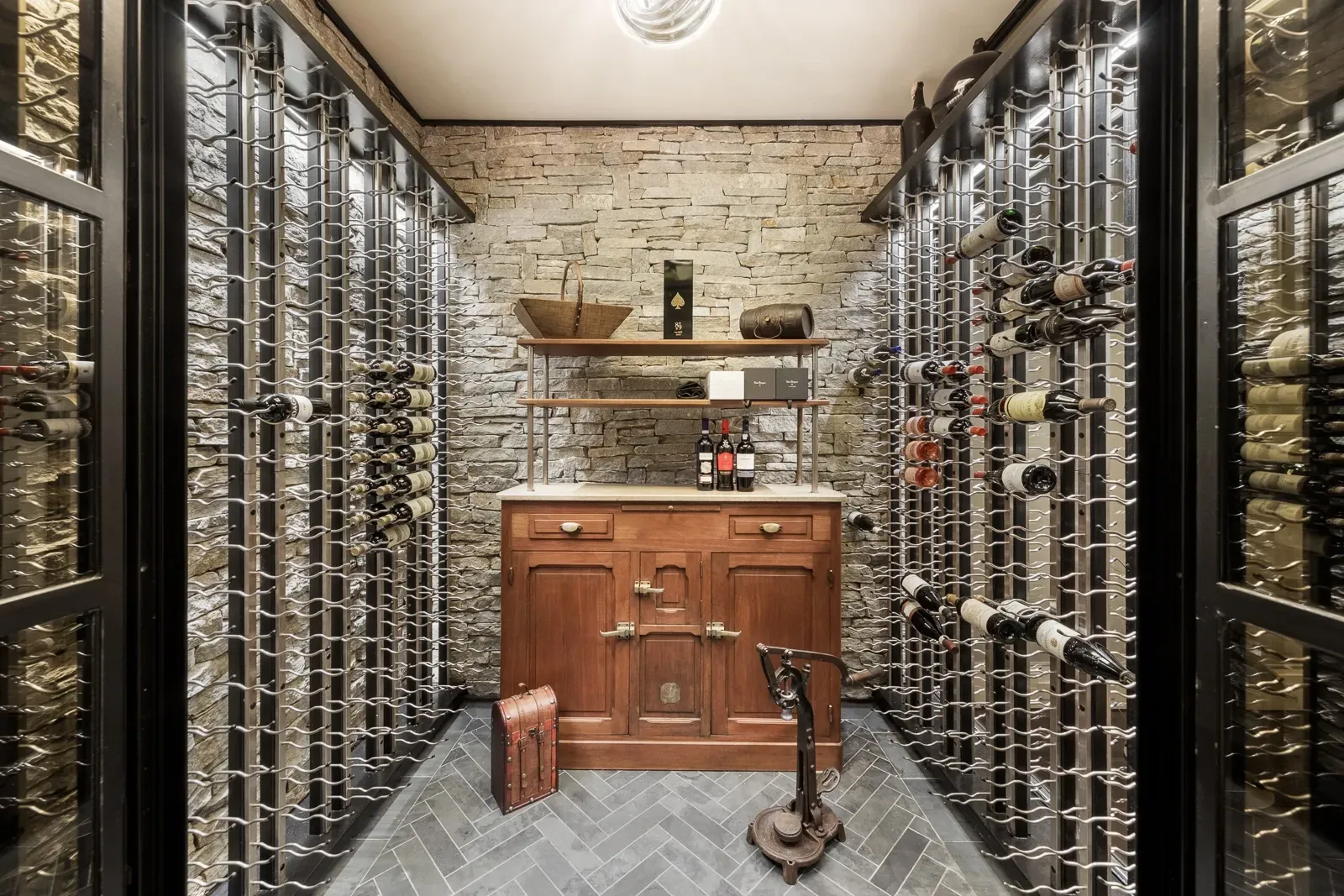 Stone-and-wood wine cellar. Floor-to-ceiling racks—who’s hosting tastings?