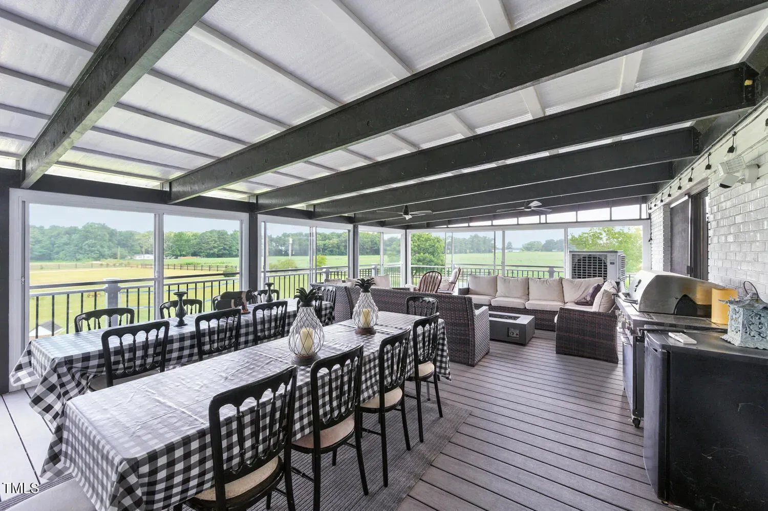 Screened porch with tall white beams. Breezy, rustic, practical. Summer hangout secured.