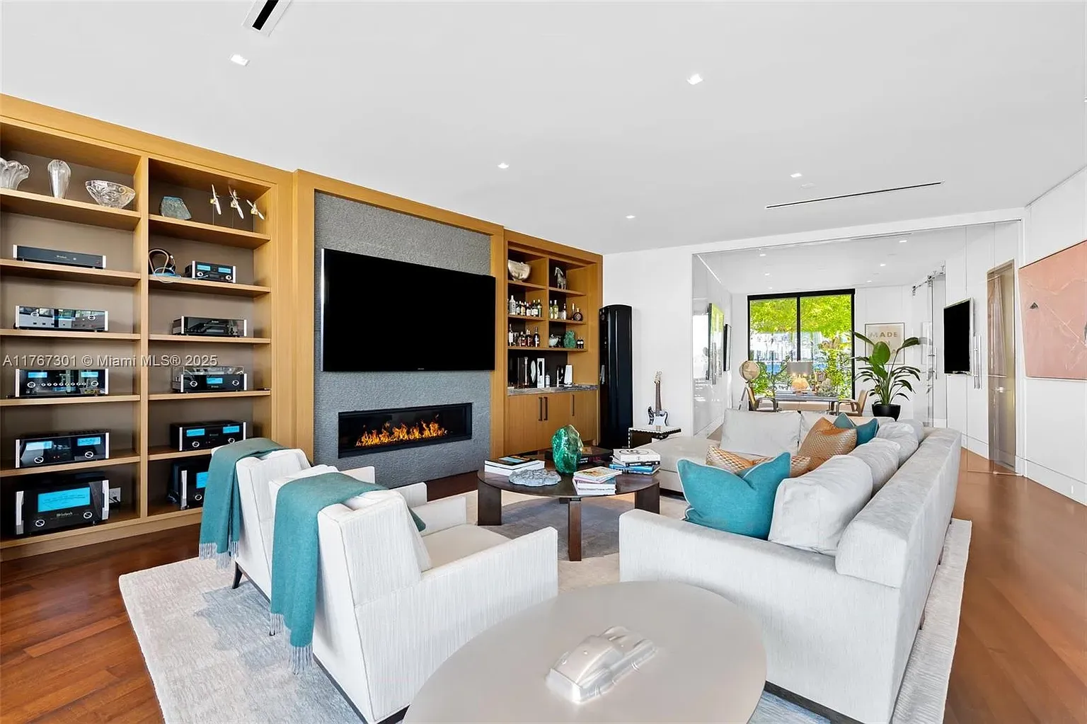 Fireplace under the TV, built-ins to the side. Clean, cozy hangout.