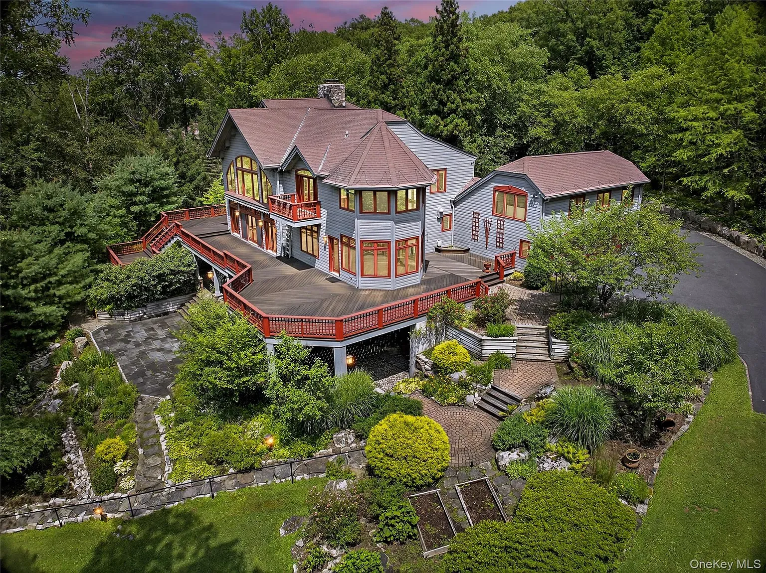 Gray siding with red trim. Kinda cabin-meets-modern. Those angles are doing something.