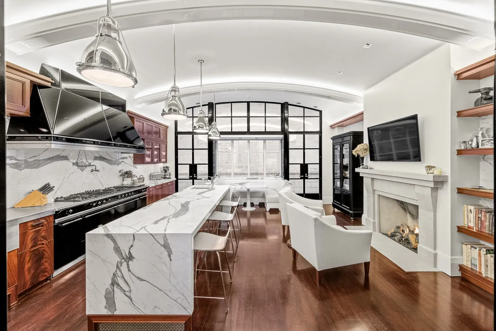 Here's the kitchen. veined marble island, sleek stools, quietly fancy.
