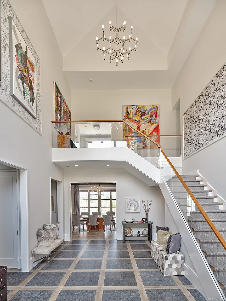 Here’s the entry—tall ceilings, big art, gray walls, polished floors.