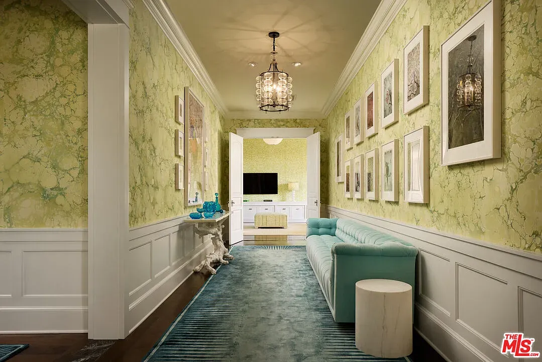 Green marbled wallpaper? Anyone know why they did this? White wainscoting kinda saves it.