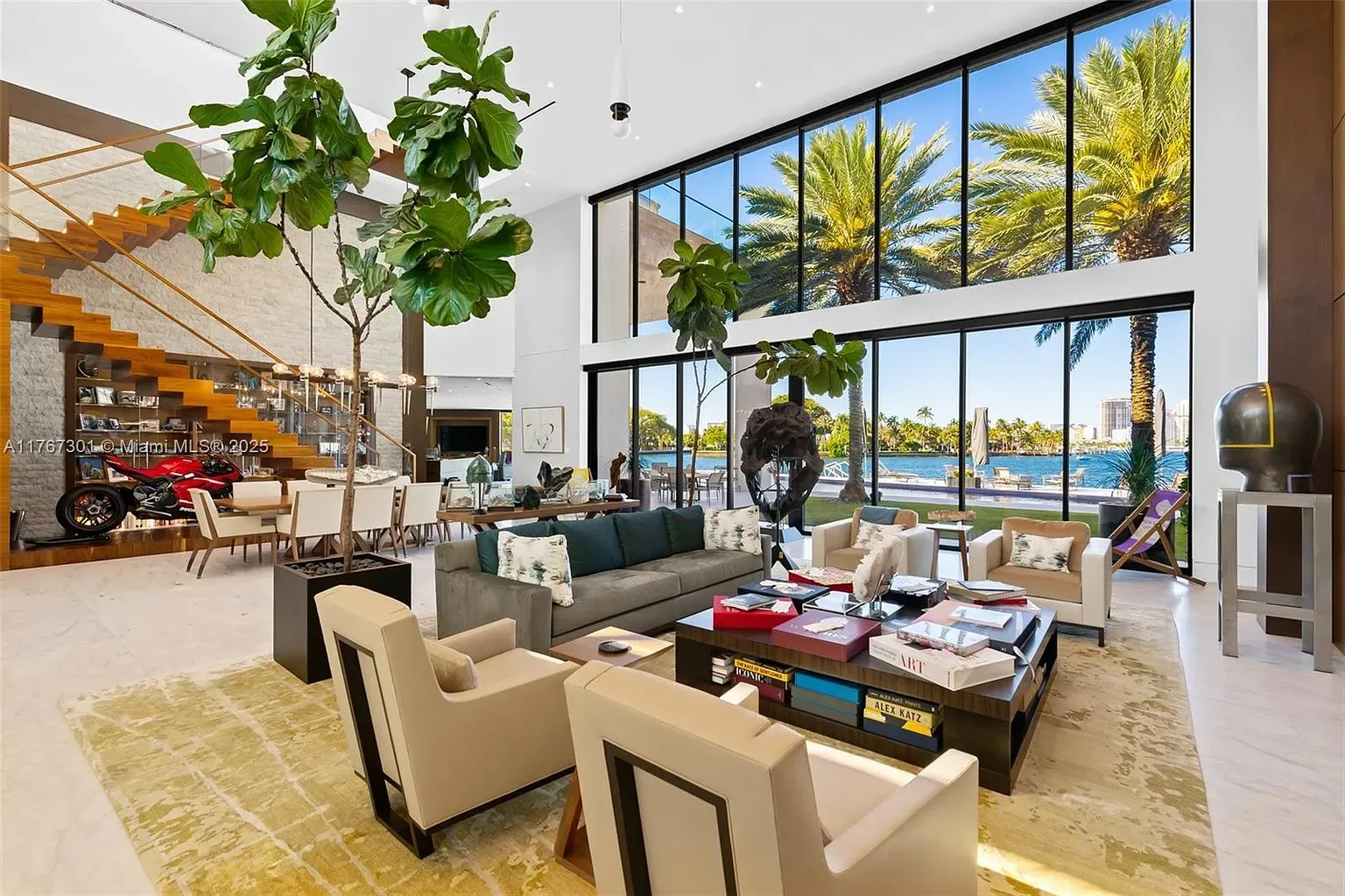 Great room wall of windows. Palms and water feel part of the furniture.