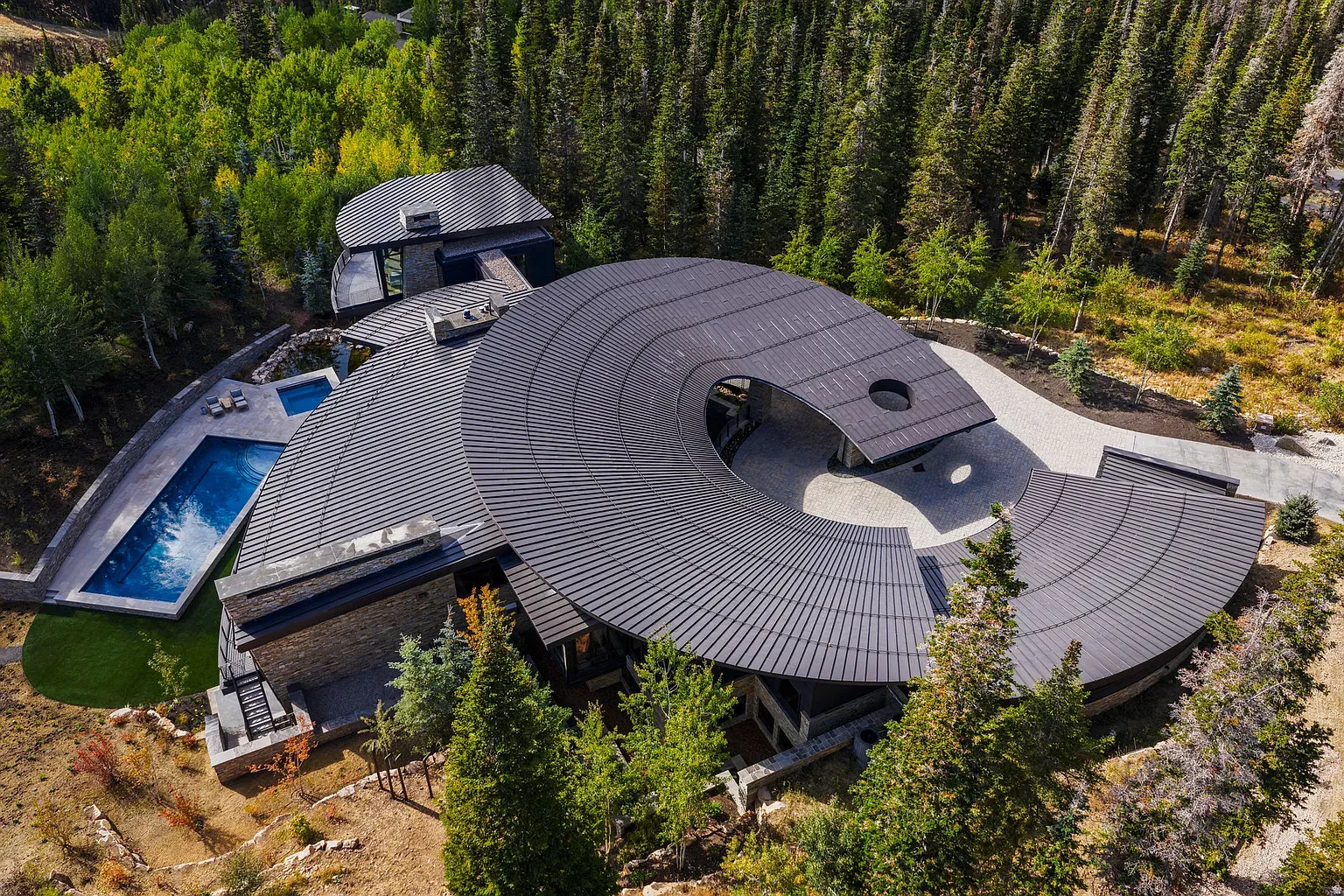 That wavy round roof is wild. a record in the trees.