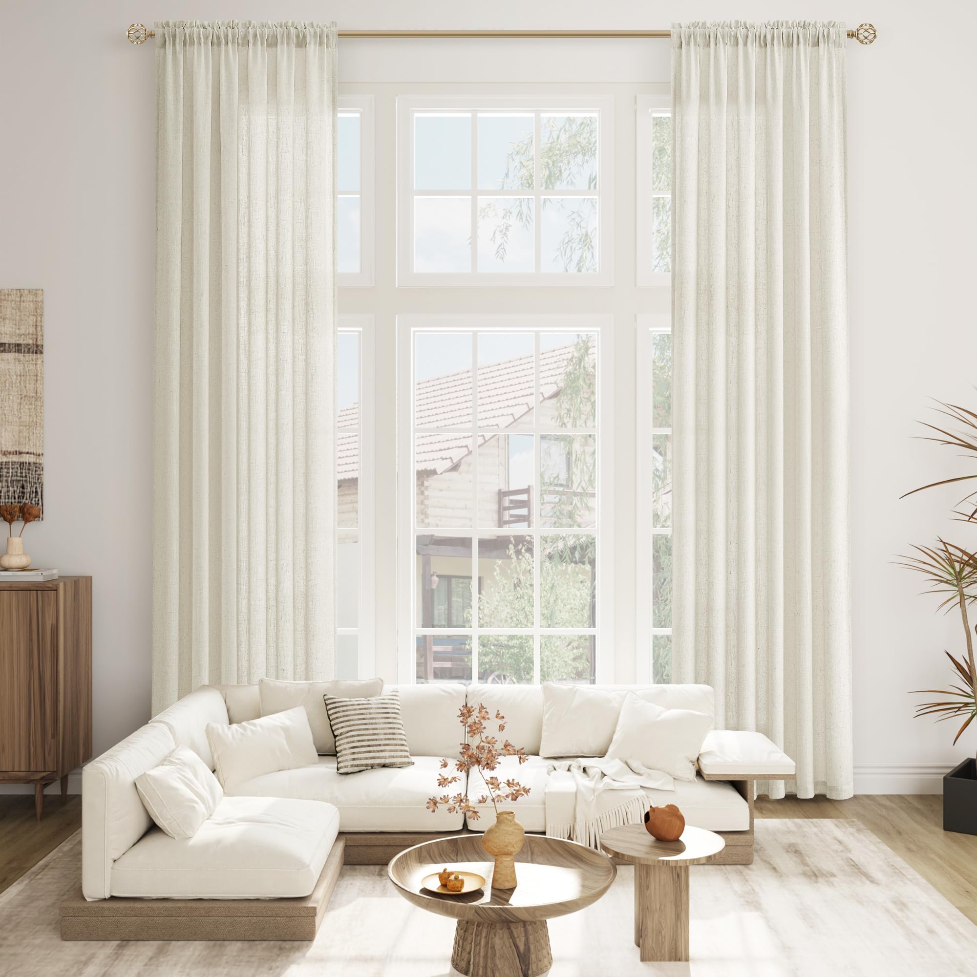 a bright living room with floor-to-ceiling curtains
