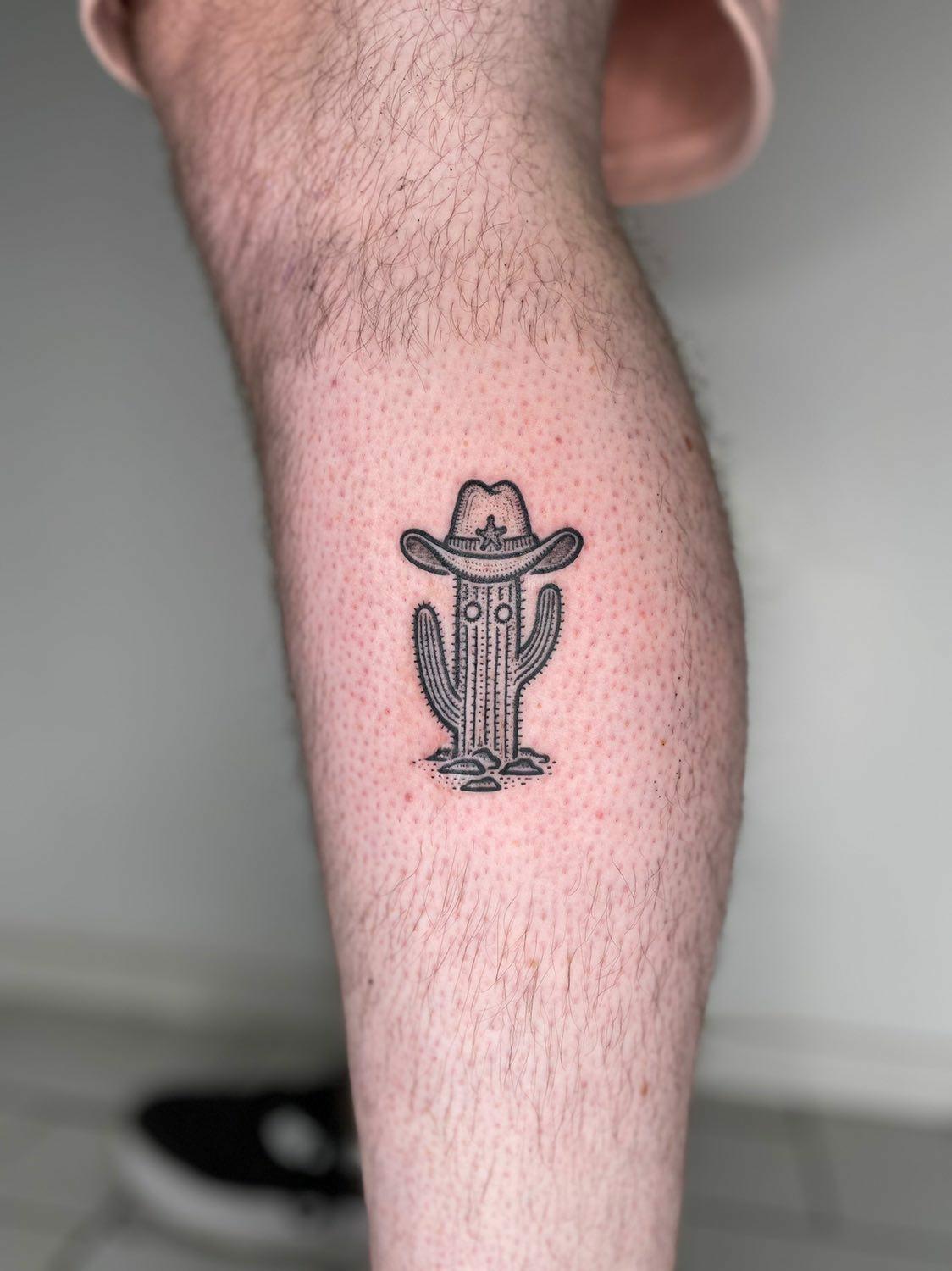 wild west with cactus-framed cowboy hat tattoos in southwest style