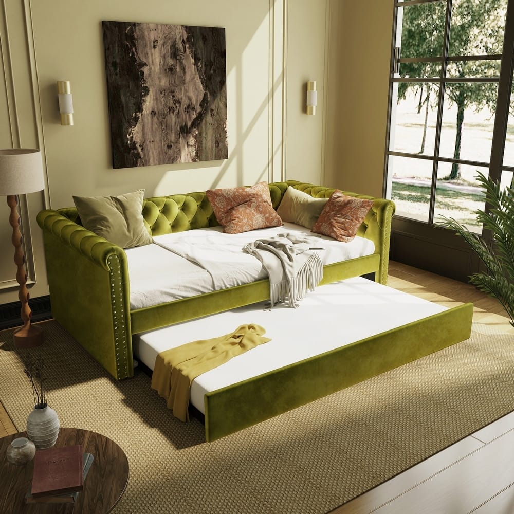 living room with lime green velvet daybed with bolster pillows and metal frame