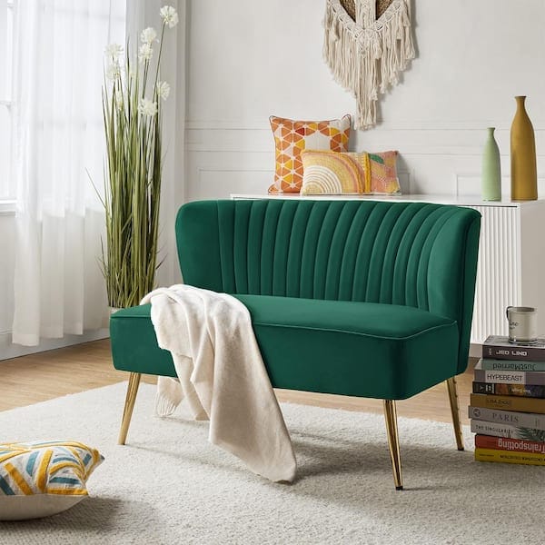 living room with forest green velvet loveseat with button tufting and brass legs