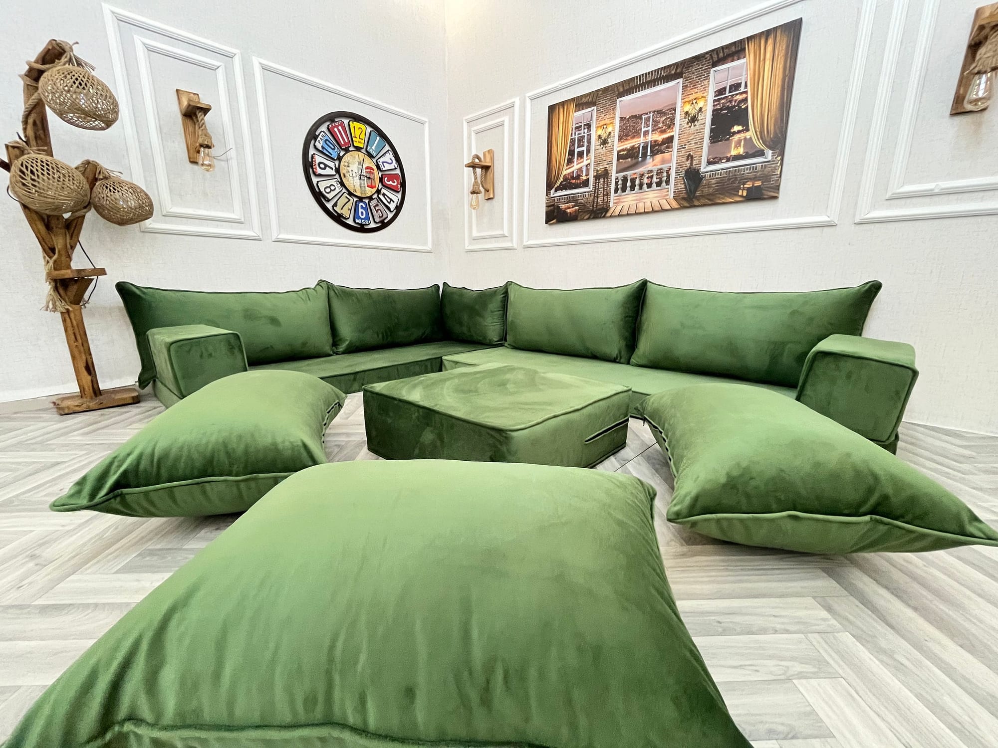 living room with pistachio green velvet corner sofa with oversized cushions