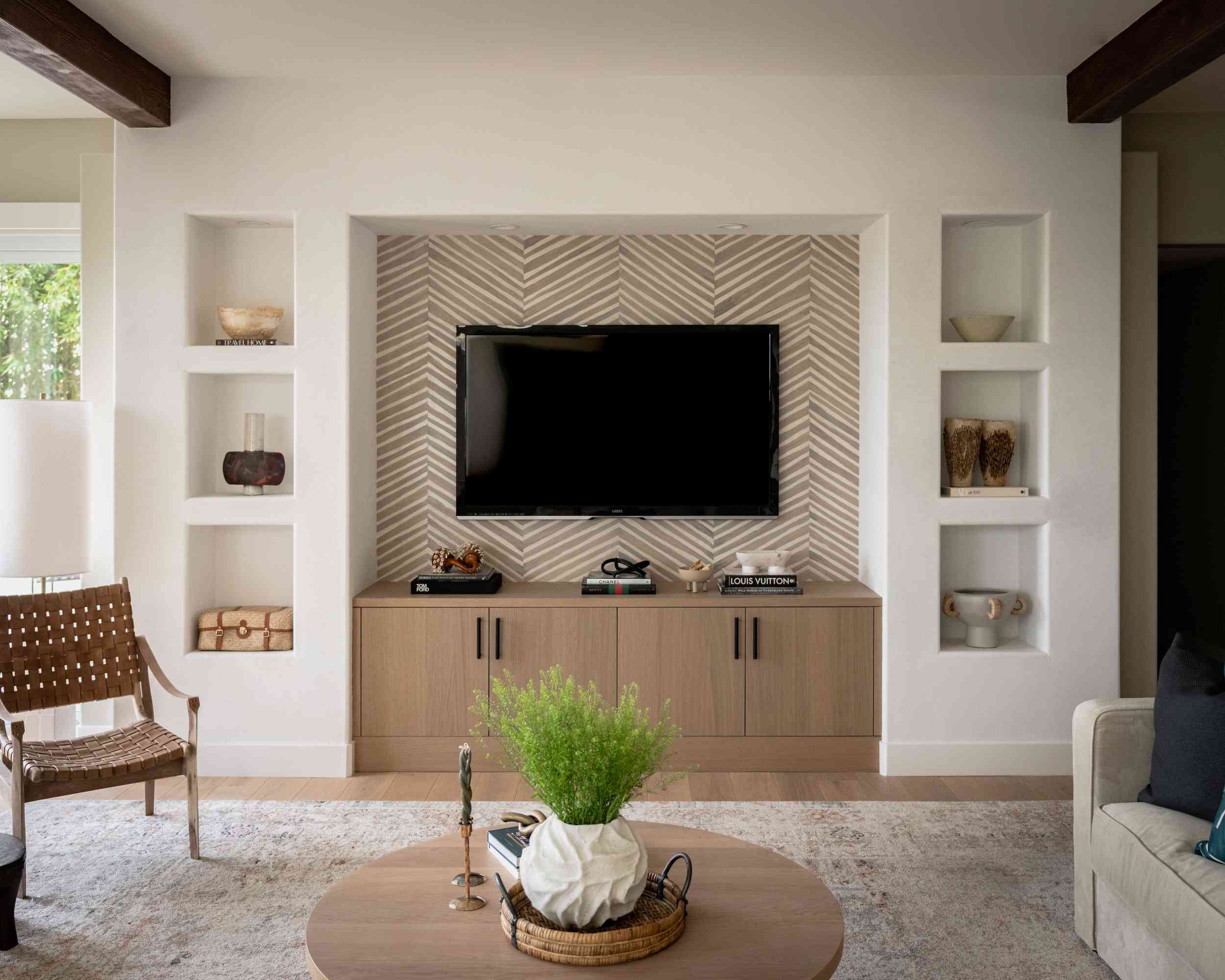 a small living room with a wall-mounted TV