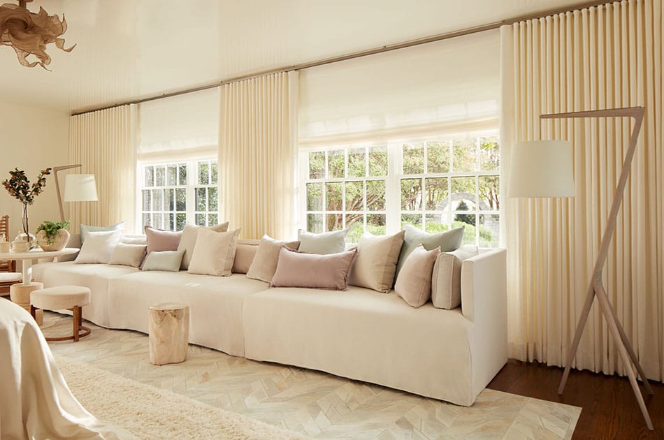 a bright living room with neutral curtains